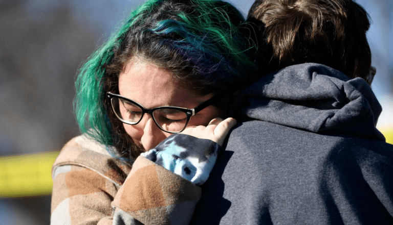 Woman being embraced outside nightclub shooting